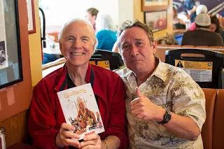 Dean Kay holding a copy of Guitarlo